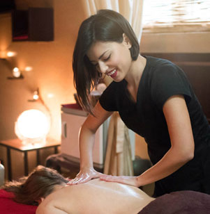 female expert therapist is doing back treatment